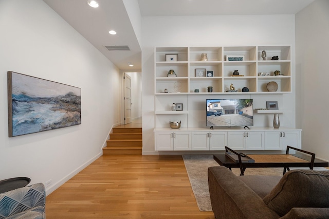 3723 Gilbert Ave, Dallas, TX 75219 - living area with light wood-style flooring, baseboards, recessed lighting, and stairs