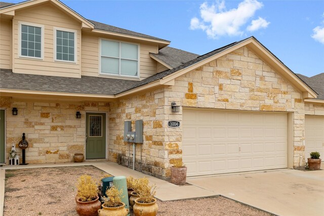 3004 Waterstone Way, Brownwood, TX 76801 - view of front of house with stone siding, a shingled roof, an attached garage, and concrete driveway