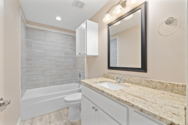 3004 Waterstone Way, Brownwood, TX 76801 - bathroom featuring toilet, vanity, wood finished floors, and shower / bathtub combination