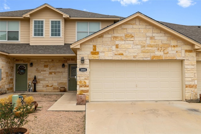 3004 Waterstone Way, Brownwood, TX 76801 - townhome / multi-family property with stone siding, roof with shingles, concrete driveway, and an attached garage