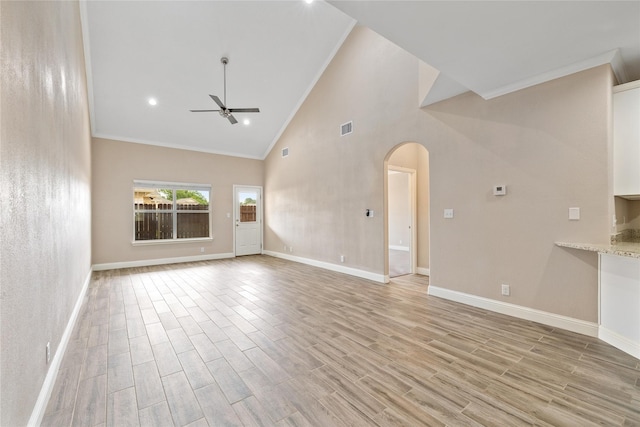 3004 Waterstone Way, Brownwood, TX 76801 - unfurnished living room featuring ceiling fan, arched walkways, crown molding, light wood-type flooring, and baseboards