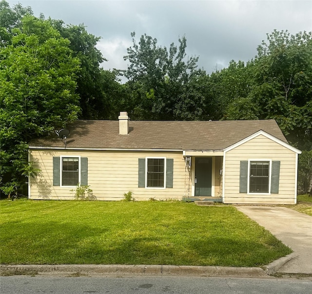 1706 N Ricketts St, Sherman, TX 75092 - ranch-style house with a front yard and a chimney
