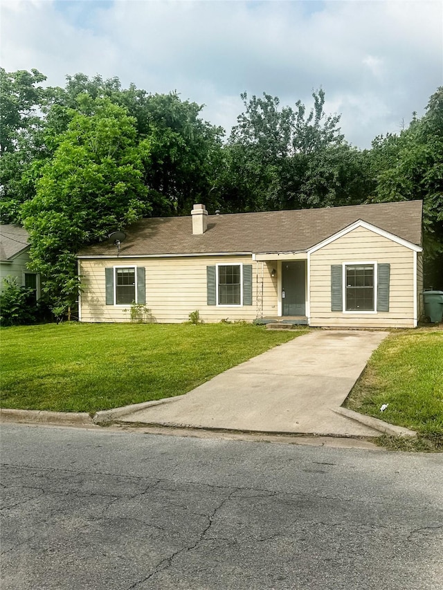 1706 N Ricketts St, Sherman, TX 75092 - single story home with a front lawn, concrete driveway, and a chimney