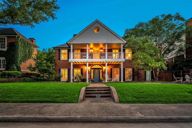 747 Kessler Lake Dr, Dallas, TX 75208 - view of front of property with a balcony, a front lawn, a porch, and brick siding