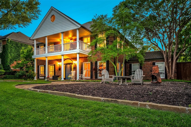 747 Kessler Lake Dr, Dallas, TX 75208 - rear view of house with a balcony, brick siding, a yard, and a porch