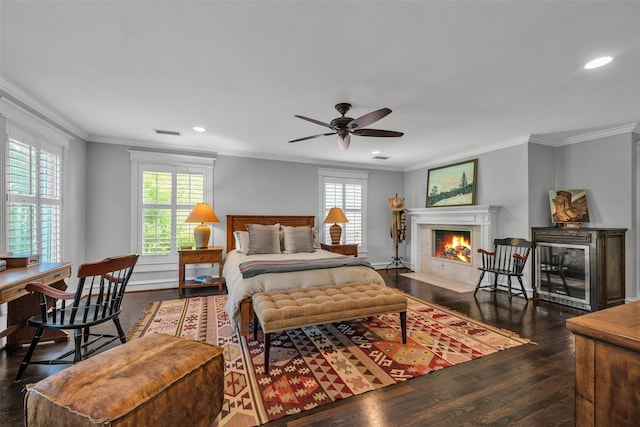 747 Kessler Lake Dr, Dallas, TX 75208 - bedroom featuring multiple windows, wood finished floors, a fireplace with flush hearth, recessed lighting, and crown molding