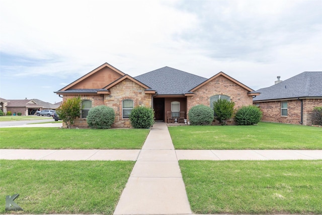 5158 Spring Creek Rd, Abilene, TX 79602 - view of front of home featuring a front lawn, stone siding, and a shingled roof
