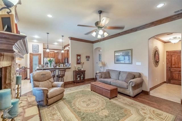 5158 Spring Creek Rd, Abilene, TX 79602 - living room featuring arched walkways, ceiling fan, crown molding, baseboards, and recessed lighting