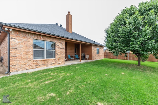 5158 Spring Creek Rd, Abilene, TX 79602 - back of property featuring a chimney, brick siding, a patio area, and a shingled roof
