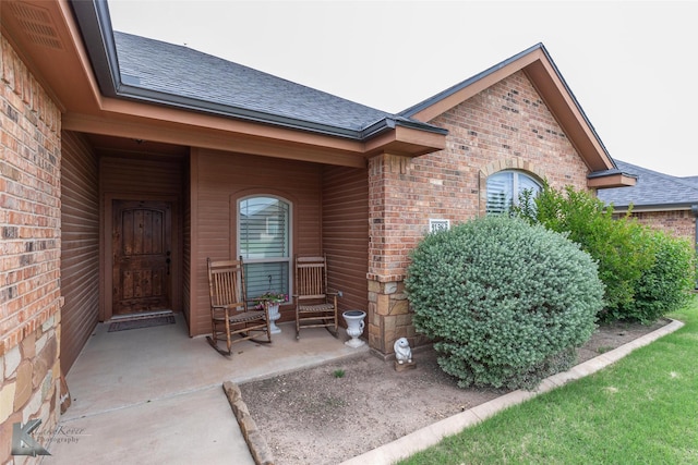 5158 Spring Creek Rd, Abilene, TX 79602 - view of exterior entry featuring roof with shingles, brick siding, and covered porch