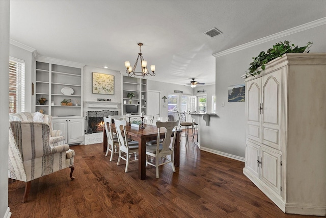 1590 N Hills Dr, Rockwall, TX 75087 - dining room with a warm lit fireplace, baseboards, ceiling fan, dark wood-style floors, and crown molding