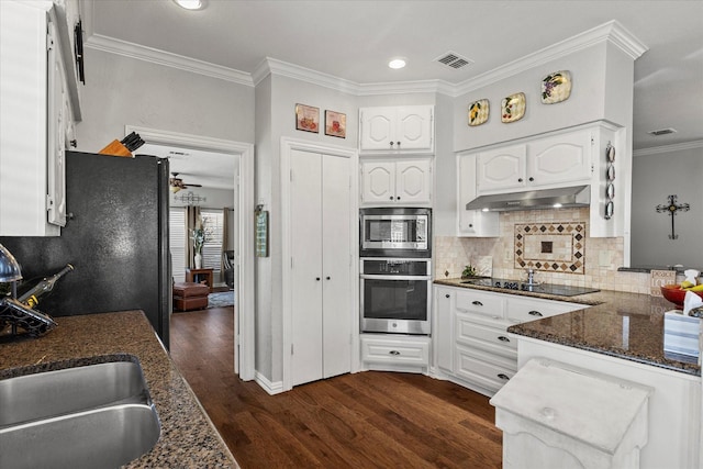 1590 N Hills Dr, Rockwall, TX 75087 - kitchen featuring black appliances, under cabinet range hood, ornamental molding, dark wood finished floors, and white cabinets