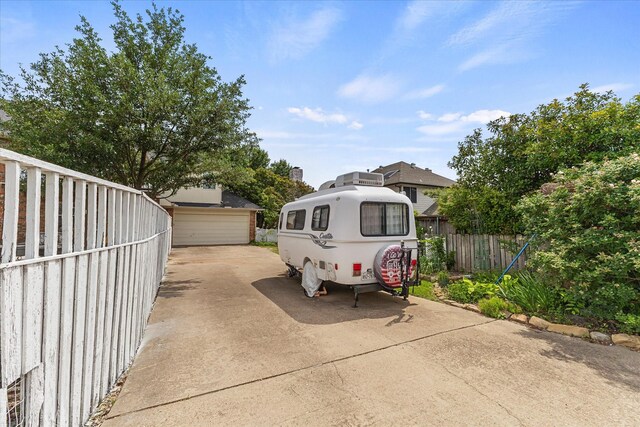 1590 N Hills Dr, Rockwall, TX 75087 - view of front of property featuring fence, a detached garage, and an outbuilding