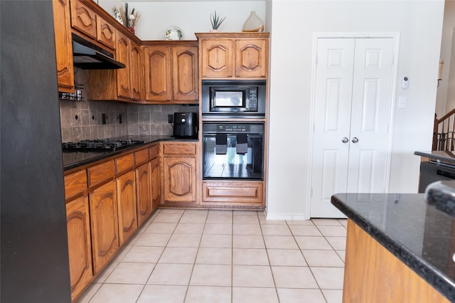 3066 Stoney Hollow Ln, Rockwall, TX 75087 - kitchen featuring black appliances, under cabinet range hood, tasteful backsplash, and brown cabinets