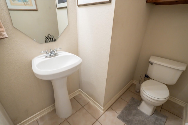 3066 Stoney Hollow Ln, Rockwall, TX 75087 - half bathroom featuring toilet, a sink, tile patterned floors, and baseboards