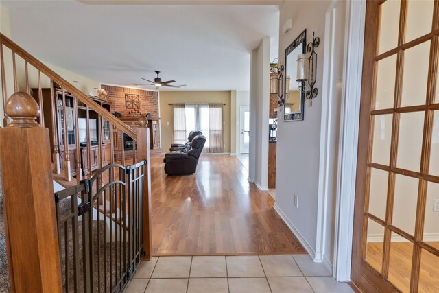3066 Stoney Hollow Ln, Rockwall, TX 75087 - foyer featuring ceiling fan, wood finished floors, baseboards, and a brick fireplace