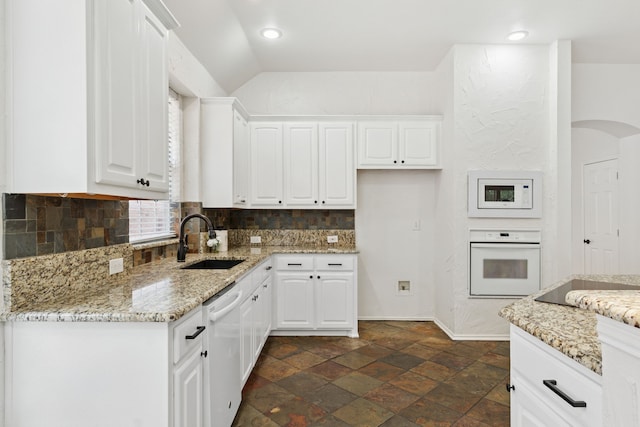 4816 Rockcreek Ln, Plano, TX 75024 - kitchen with white appliances, a sink, tasteful backsplash, light stone counters, and white cabinets