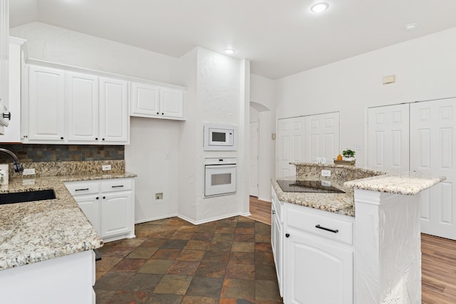 4816 Rockcreek Ln, Plano, TX 75024 - kitchen featuring white appliances, arched walkways, white cabinetry, and recessed lighting