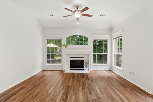 4816 Rockcreek Ln, Plano, TX 75024 - unfurnished living room featuring wood finished floors, baseboards, a tiled fireplace, and a ceiling fan