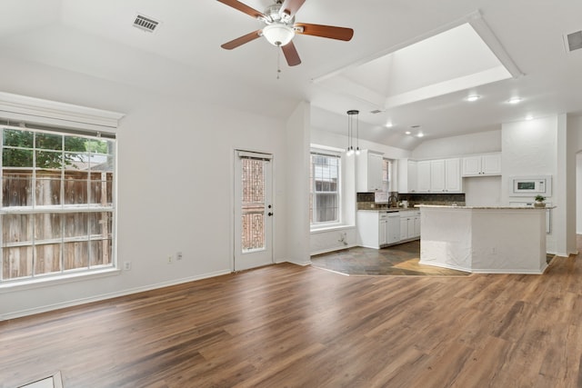 4816 Rockcreek Ln, Plano, TX 75024 - unfurnished living room with vaulted ceiling, a ceiling fan, dark wood-style floors, baseboards, and a sink