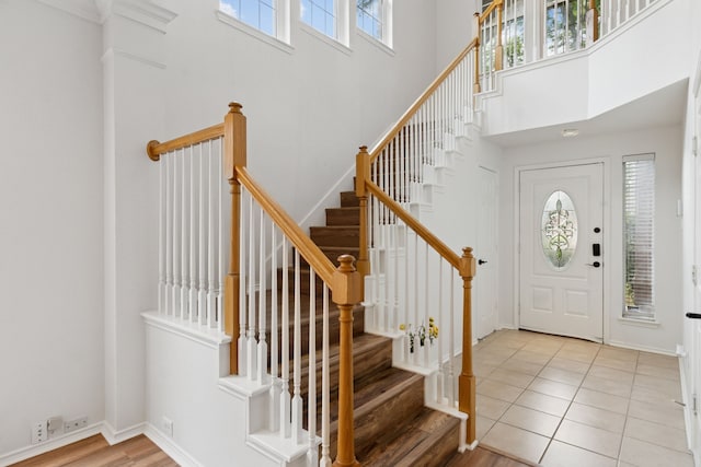 4816 Rockcreek Ln, Plano, TX 75024 - foyer featuring a towering ceiling, stairway, light wood-style flooring, and baseboards
