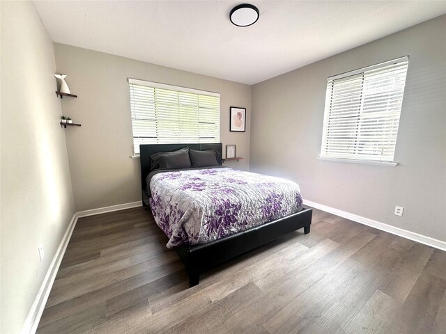 bedroom with wood finished floors and baseboards