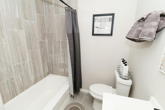 full bathroom with toilet, tile patterned floors, shower / tub combo, and baseboards