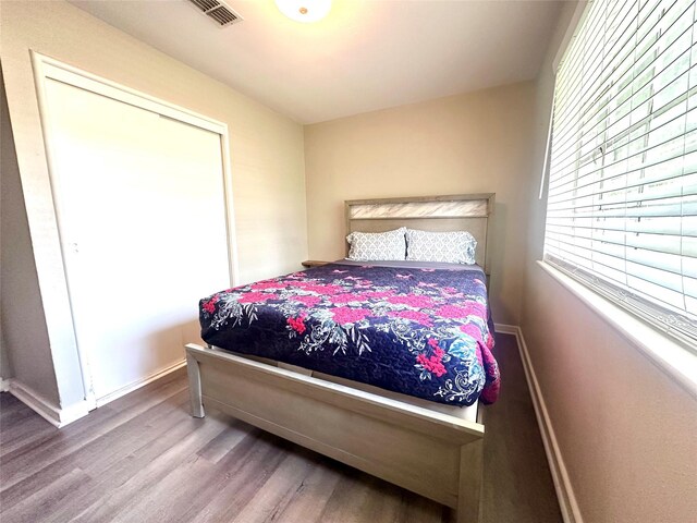 bedroom featuring wood finished floors and baseboards