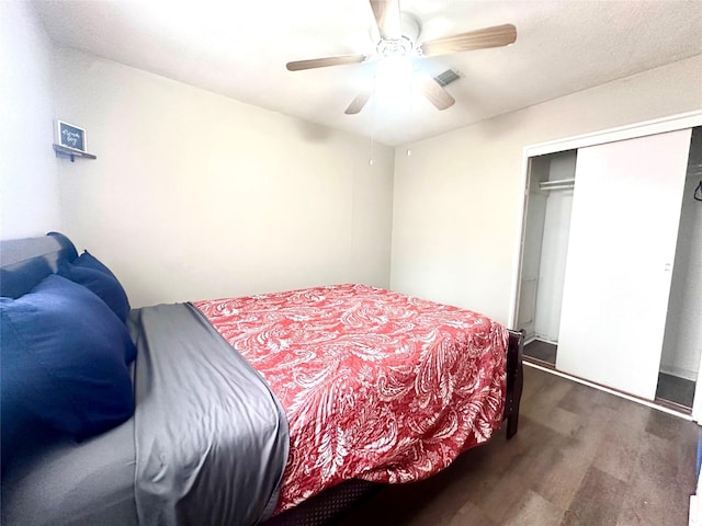 bedroom featuring a closet, wood finished floors, and ceiling fan