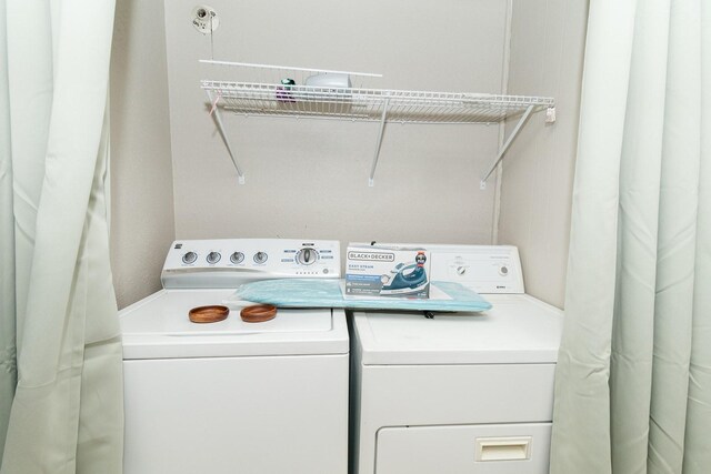 clothes washing area featuring washing machine and clothes dryer