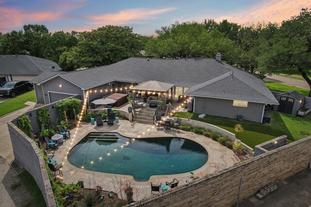4222 Laren Ln, Dallas, TX 75244 - pool at dusk with an outdoor living space, a gazebo, a patio, outdoor dining space, and a storage unit