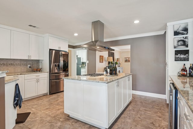 4222 Laren Ln, Dallas, TX 75244 - kitchen featuring stainless steel appliances, island exhaust hood, a kitchen island, white cabinetry, and crown molding