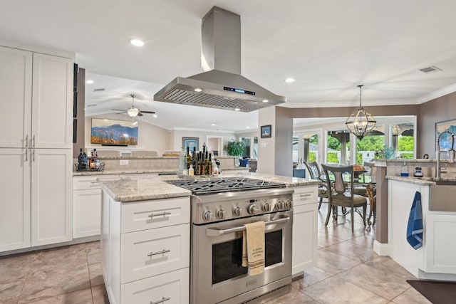 4222 Laren Ln, Dallas, TX 75244 - kitchen with high end range, extractor fan, white cabinetry, light stone counters, and crown molding