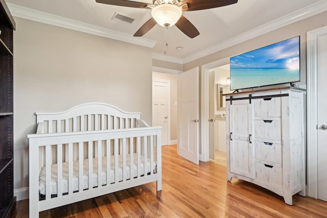 4222 Laren Ln, Dallas, TX 75244 - bedroom featuring wood finished floors, ornamental molding, a crib, and ceiling fan