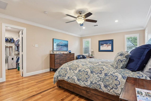 4222 Laren Ln, Dallas, TX 75244 - bedroom featuring light wood-style flooring, multiple windows, baseboards, ornamental molding, and a walk in closet