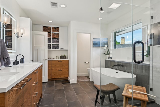 4222 Laren Ln, Dallas, TX 75244 - full bath featuring a soaking tub, double vanity, recessed lighting, a shower stall, and tile patterned floors