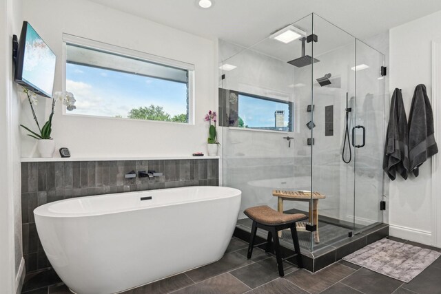 4222 Laren Ln, Dallas, TX 75244 - bathroom with tile walls, a freestanding bath, a shower stall, and tile patterned flooring