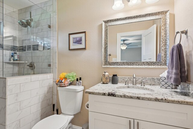 4222 Laren Ln, Dallas, TX 75244 - full bathroom with tiled shower, toilet, vanity, and ceiling fan