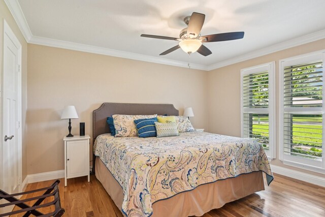 4222 Laren Ln, Dallas, TX 75244 - bedroom with multiple windows, baseboards, wood finished floors, crown molding, and a ceiling fan