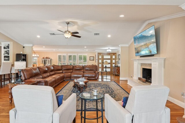 4222 Laren Ln, Dallas, TX 75244 - living area with ornamental molding, wood finished floors, a ceiling fan, vaulted ceiling, and a tile fireplace