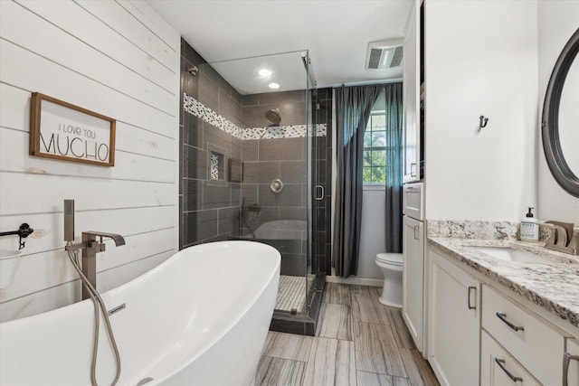 168 Barker Ln, Waco, TX 76705 - bathroom with vanity, a shower stall, a soaking tub, toilet, and recessed lighting