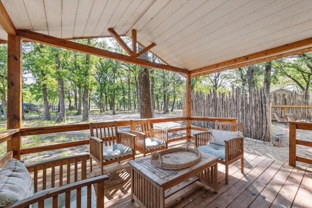 168 Barker Ln, Waco, TX 76705 - deck featuring an outdoor living space, view of wooded area, and fence
