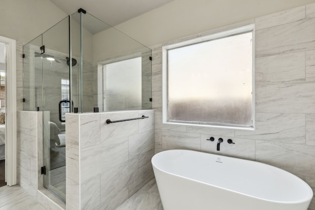 2111 Rheims Dr, Carrollton, TX 75006 - bathroom with a soaking tub, a shower stall, and tile walls