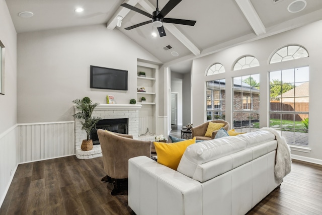 2111 Rheims Dr, Carrollton, TX 75006 - living area with beam ceiling, ceiling fan, dark wood finished floors, built in features, and a fireplace