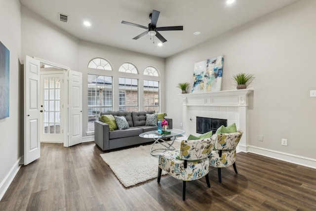 2111 Rheims Dr, Carrollton, TX 75006 - living room featuring dark wood-style flooring, recessed lighting, a tiled fireplace, ceiling fan, and baseboards