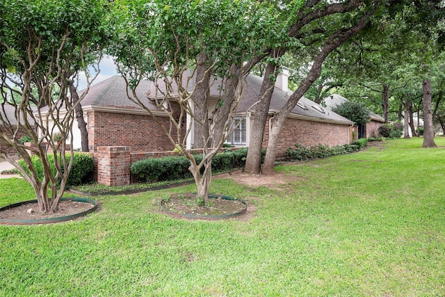 4728 Misty Oak Ln, Arlington, TX 76017 - view of property exterior featuring brick siding, a yard, a chimney, and roof with shingles