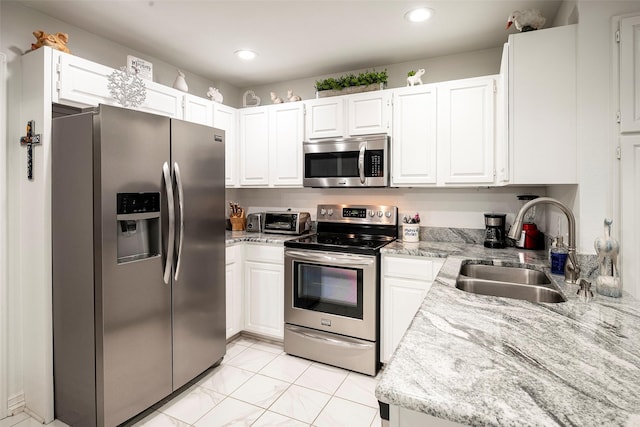 4728 Misty Oak Ln, Arlington, TX 76017 - kitchen with appliances with stainless steel finishes, a sink, white cabinetry, and recessed lighting