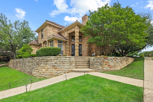2320 Table Rock Ct, Arlington, TX 76006 - view of front of house featuring brick siding, a front yard, and a chimney