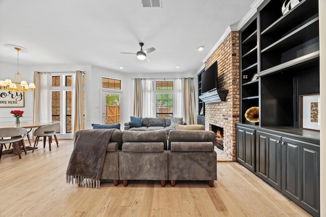 2320 Table Rock Ct, Arlington, TX 76006 - living area featuring a chandelier, ceiling fan, light wood finished floors, a brick fireplace, and ornamental molding