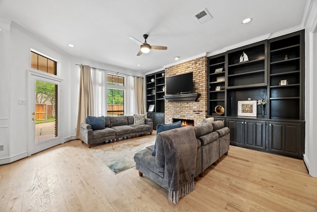 2320 Table Rock Ct, Arlington, TX 76006 - living room with crown molding, light wood finished floors, ceiling fan, a brick fireplace, and recessed lighting